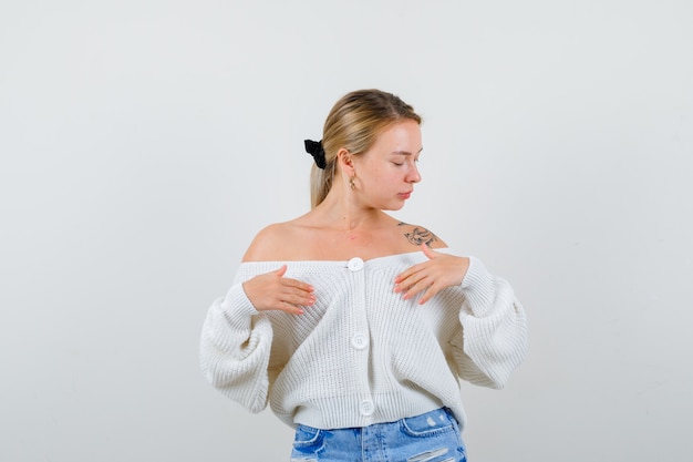 Free Photo young blonde woman in a white cardigan