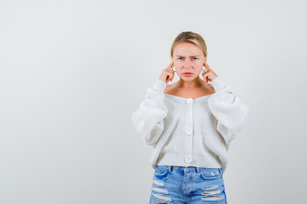 Young blonde woman in a white cardigan