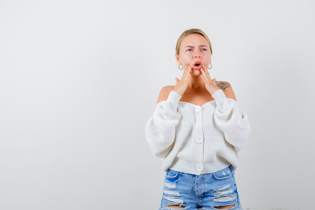 Free Photo young blonde woman in a white cardigan