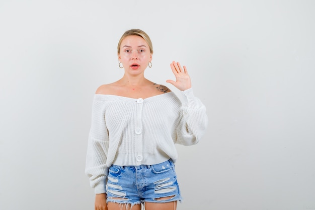 Young blonde woman in a white cardigan