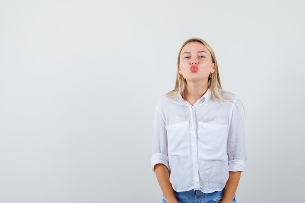 Free photo young blonde woman in a white shirt