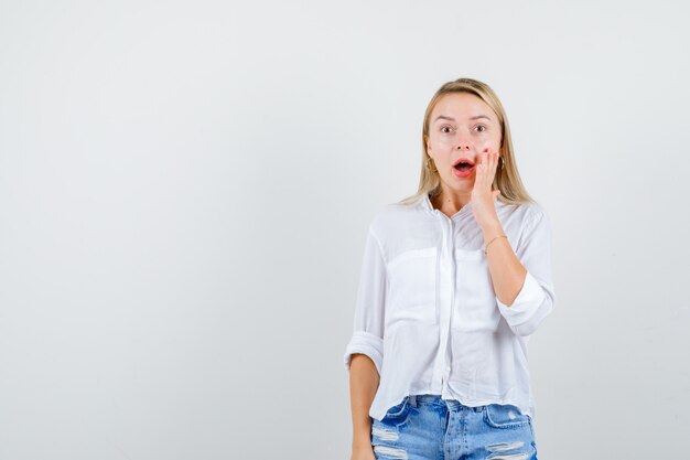 Young blonde woman in a white shirt