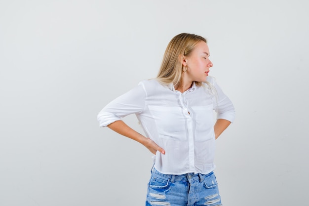 Free photo young blonde woman in a white shirt