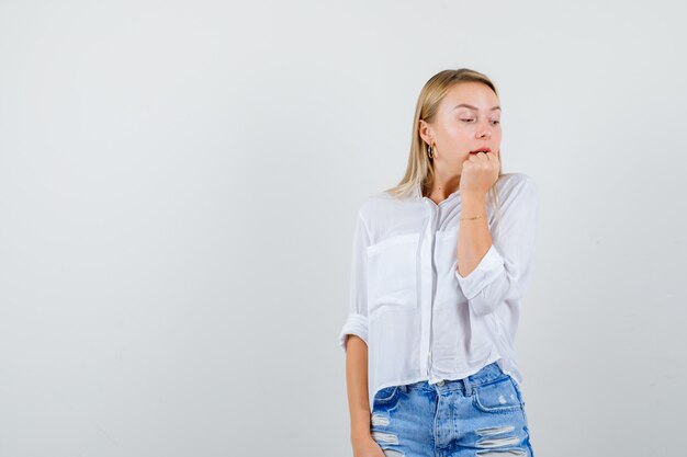 Young blonde woman in a white shirt