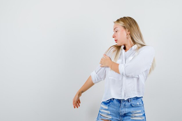 Young blonde woman in a white shirt