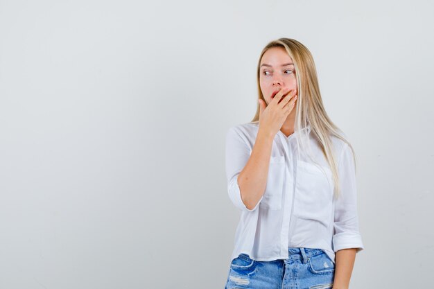 Young blonde woman in a white shirt