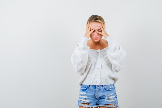 Free photo young blonde woman in a white sweater