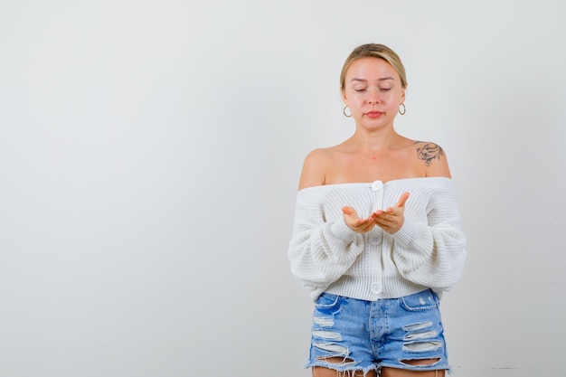 Free photo young blonde woman in a white sweater