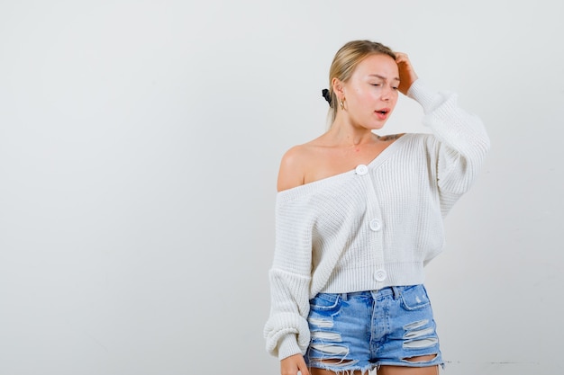 Young blonde woman in a white sweater