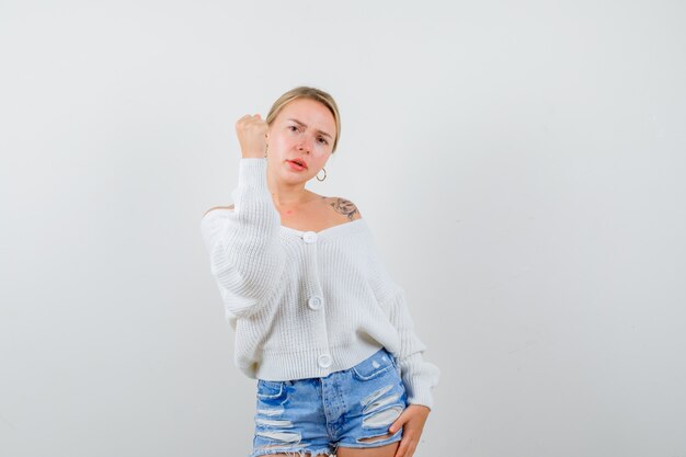 Young blonde woman in a white sweater