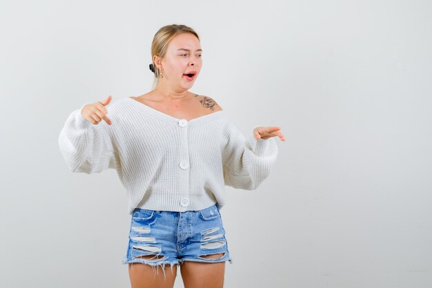 Young blonde woman in a white sweater