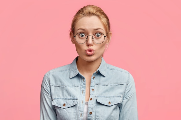 Young blonde woman with round glasses