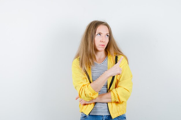 Young blonde woman in a yellow jacket