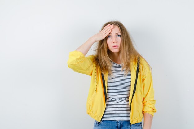 Young blonde woman in a yellow jacket