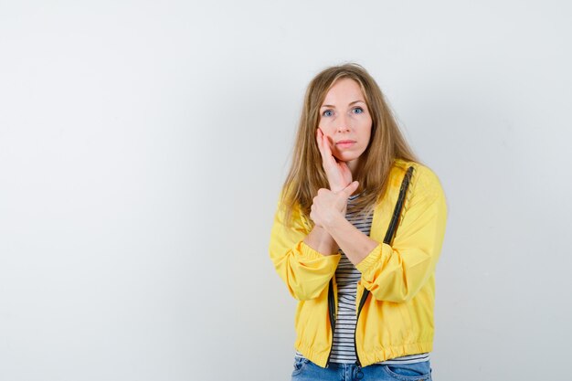 Young blonde woman in a yellow jacket