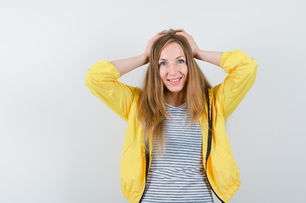 Young blonde woman in a yellow jacket