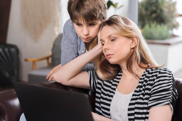 Young boy curious to see mothers work