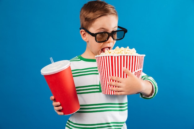 Young boy in eyeglasses preparing to watch the film