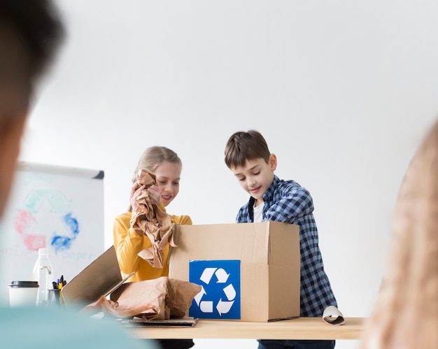 Free Photo young boy and girl learning how to recycle