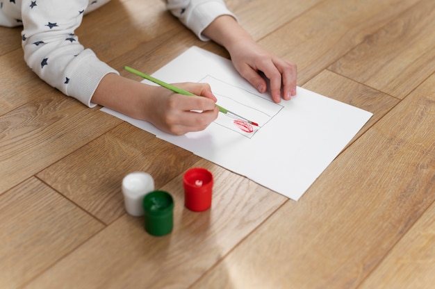 Free photo young boy painting the bulgarian flag at home