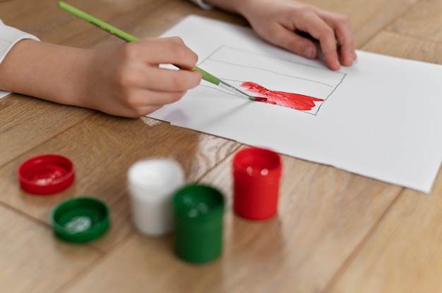 Free photo young boy painting the bulgarian flag at home