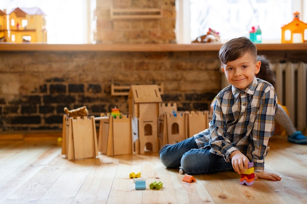 Free photo young boy playing indoors with eco toys