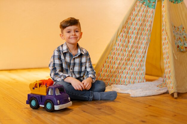 Young boy playing indoors with eco toys