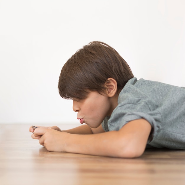 Young boy playing on smartphone