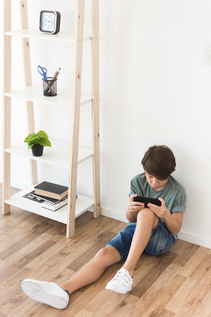 Young boy playing on smartphone