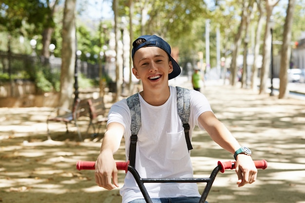 Young boy riding a BMX bike in park