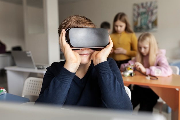 Free photo young boy trying out vr glasses and having fun