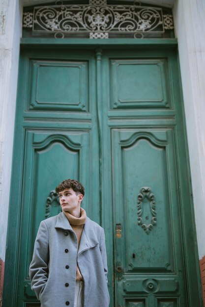 Young boy with coat at front door