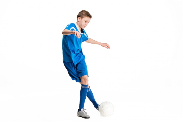 Young boy with soccer ball doing flying kick