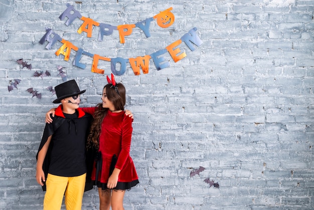 Free photo young brothers together ready for halloween