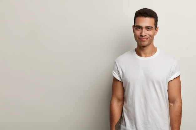 Young brunet man wearing white T-shirt