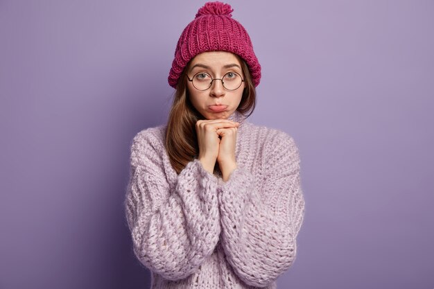 Young brunette woman in cozy winter clothes