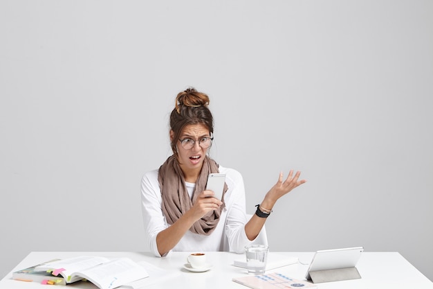 Young brunette woman sitting at desk