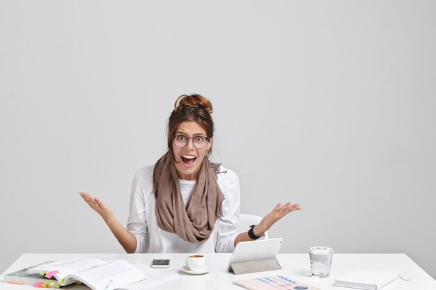 Young brunette woman sitting at desk