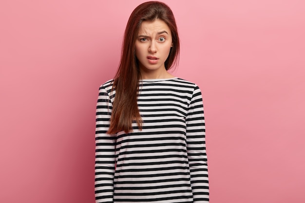 Young brunette woman in striped shirt