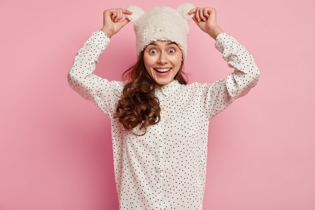 Young brunette woman wearing funny hat