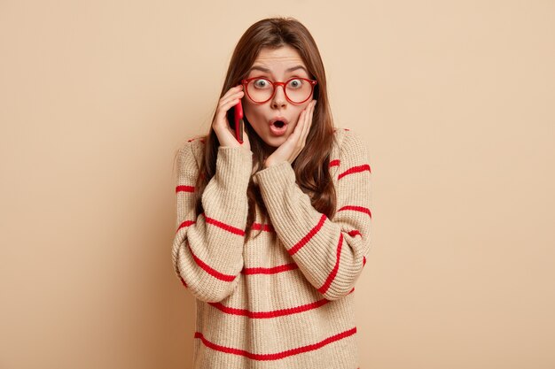 Young brunette woman wearing red eyeglasses