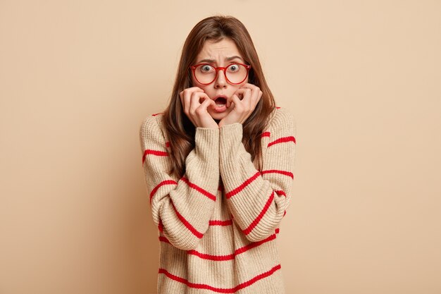 Young brunette woman wearing red glasses