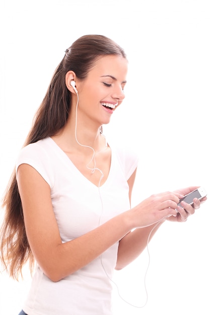 Young brunette woman with earphones and smartphone