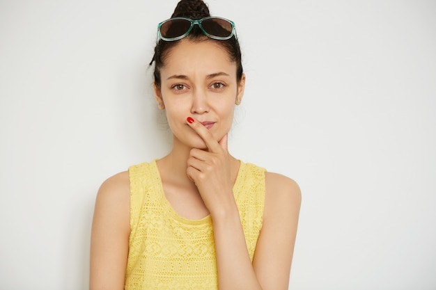 Free photo young brunette woman with hair in a bun