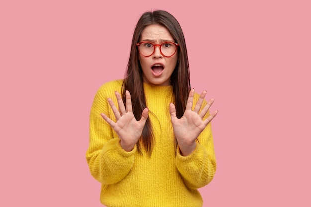 Free photo young brunette woman in yellow sweater