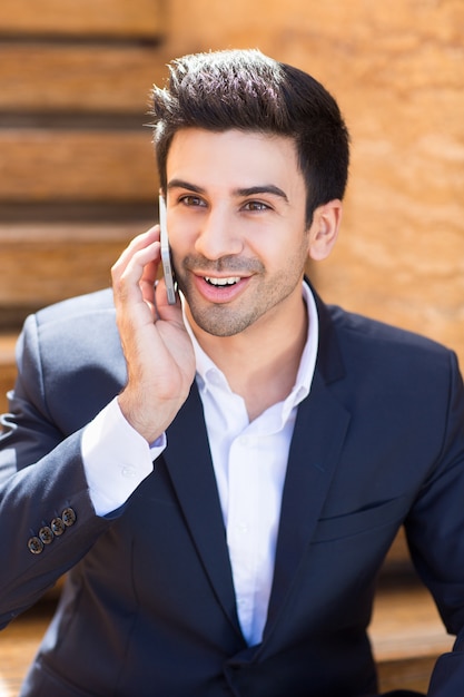 Young business man smiling talking on the phone