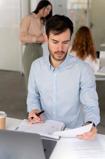 Young business man working at her desk with laptop