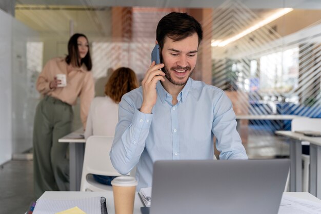 Young business man working at her desk with laptop