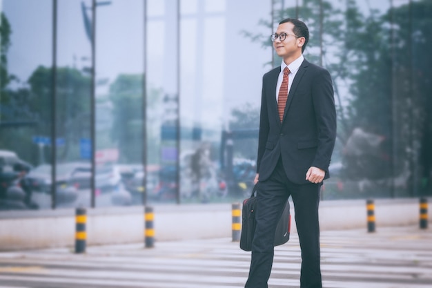 Young business men walk at the entrance of an office building