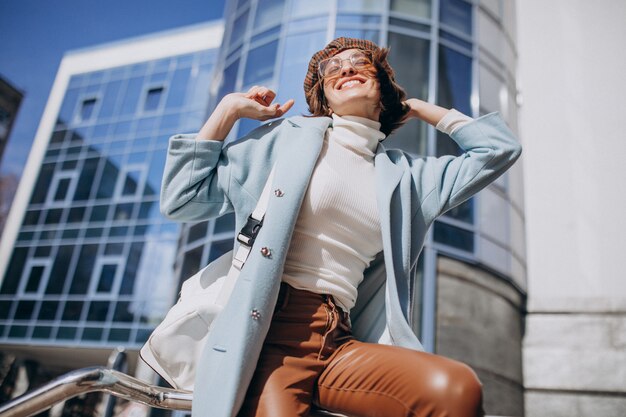 Young business woman in casual outfit by the business center